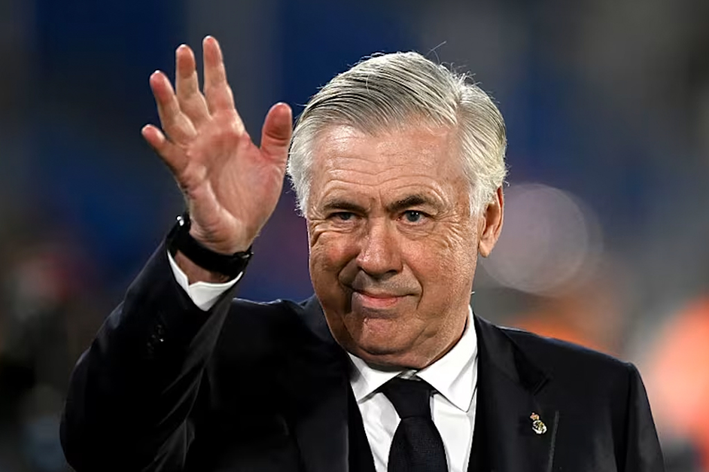 Imagem do Carlo Ancelotti. Homem de cabelos grisalhos, usando terno escuro.