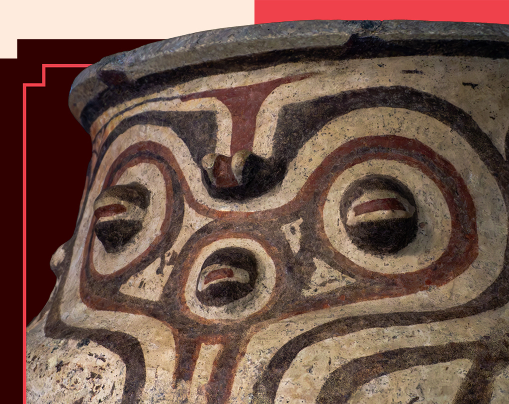 Vaso de cerâmica pré-colombiana com pintura em tons terrosos, formando padrões circulares e linhas que lembram um rosto estilizado com olhos e boca. O fundo é marrom escuro com detalhes em vermelho e bege